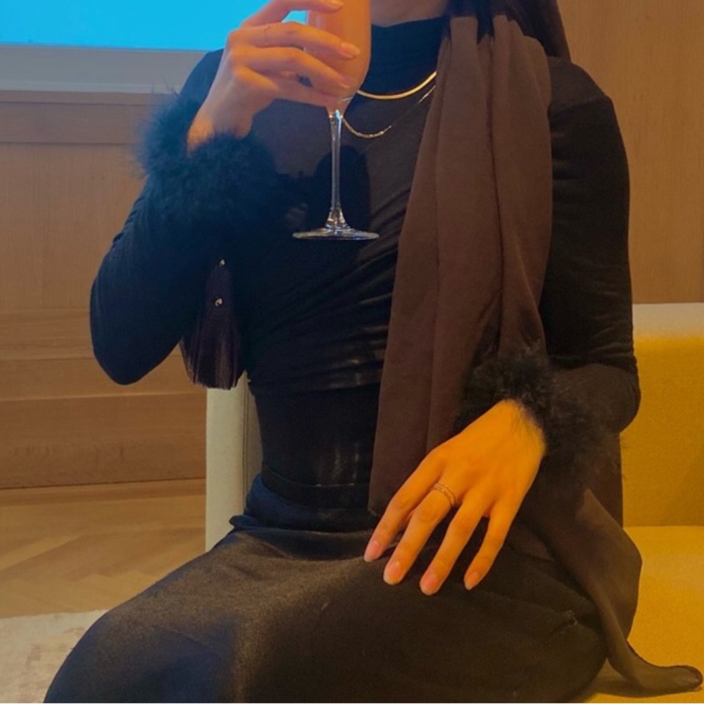 black cropped top with feathery sleeves